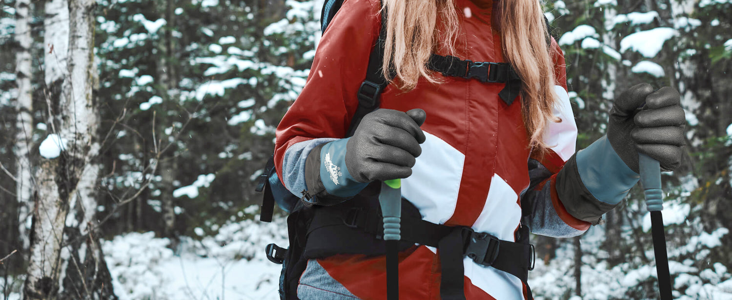 Person in a red jacket with a backpack in a snowy forest