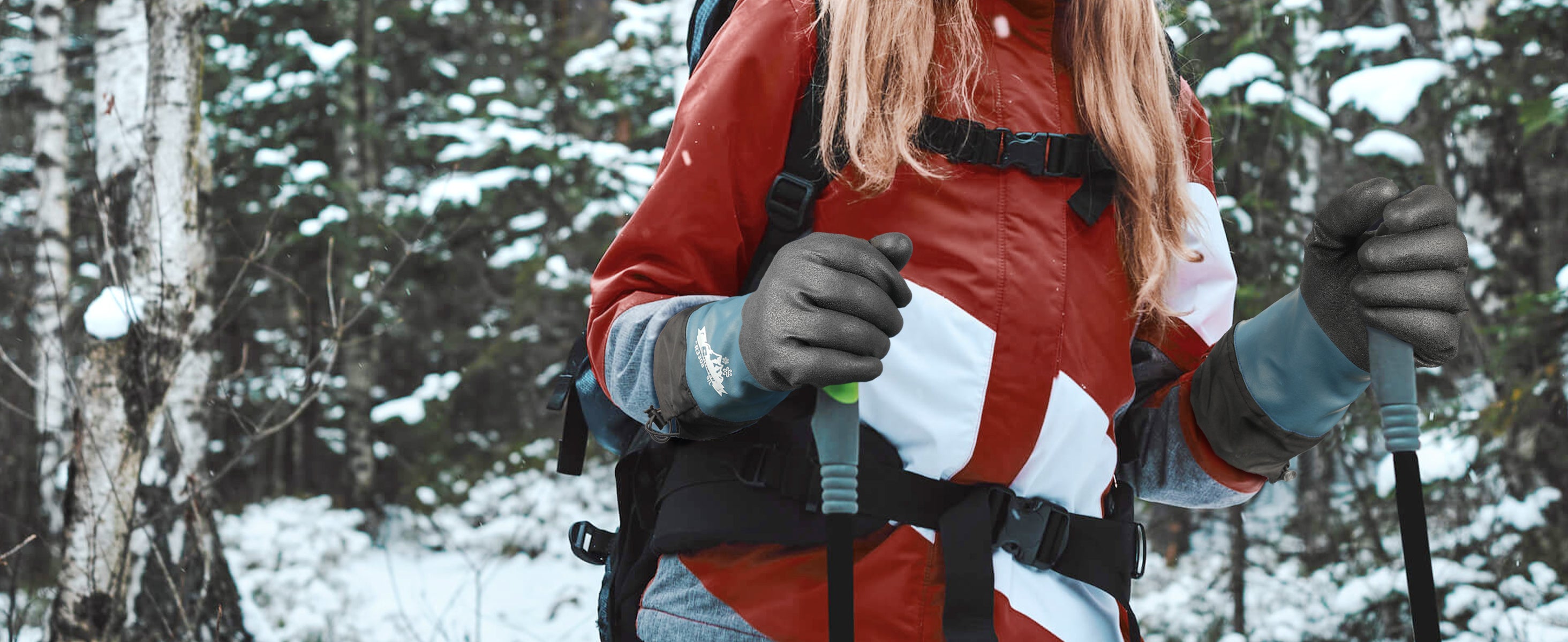 Person in a red jacket with a backpack in a snowy forest