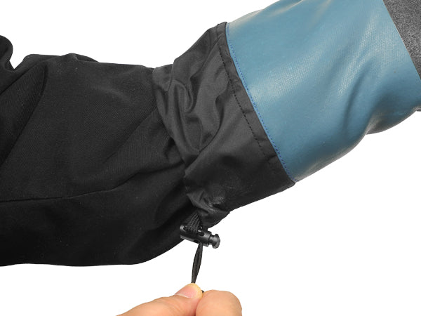 Close-up of a black and blue raincoat sleeve with a hand holding it.