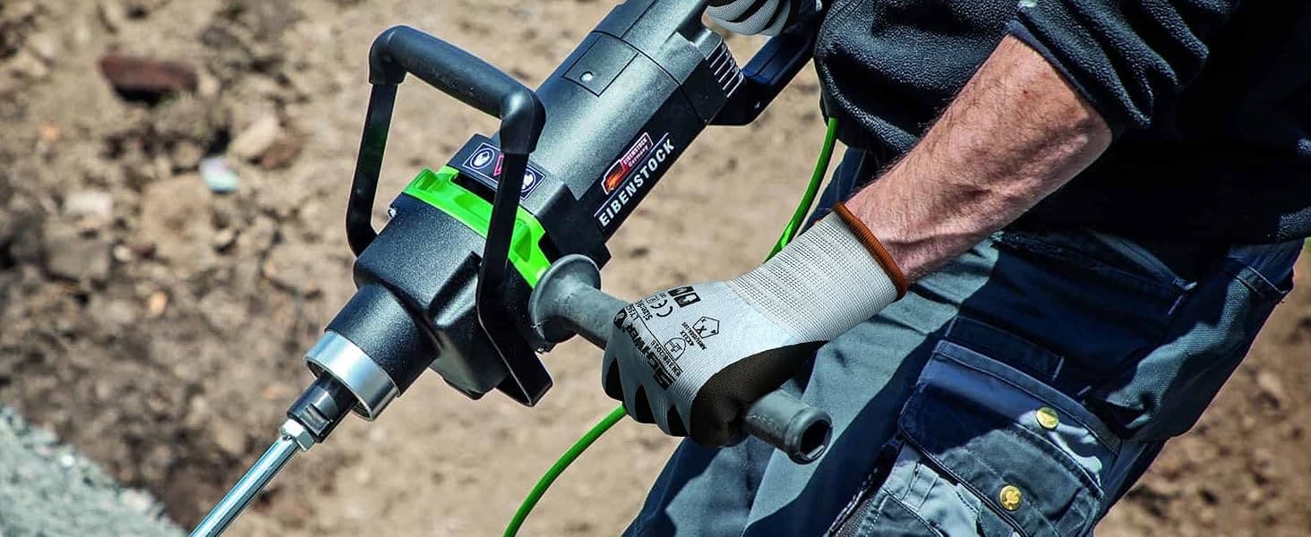 Person using a power tool on a construction site