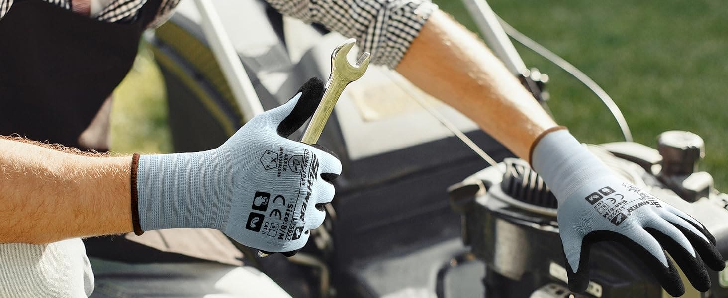 Person wearing gloves holding a wrench, working on a vehicle.