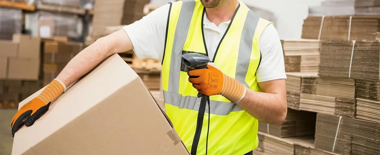 Worker in a warehouse holding a box and using a barcode scanner.