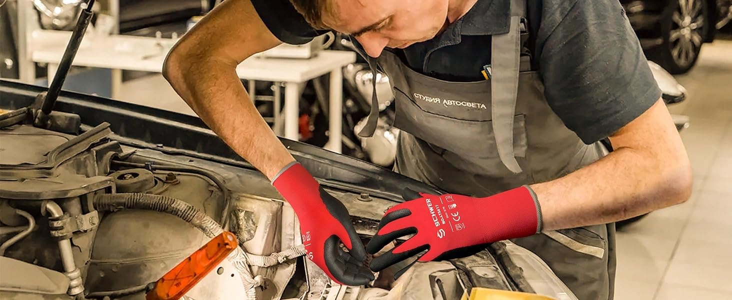 Mechanic working on a car with red gloves in a workshop setting