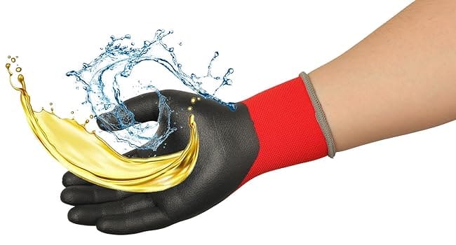 Hand wearing a black and red glove with oil and water splashes