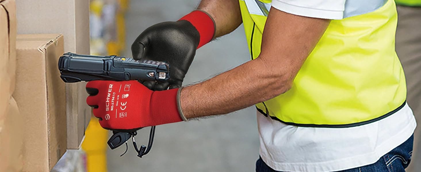 Person in a high-visibility vest using a handheld device in an industrial setting