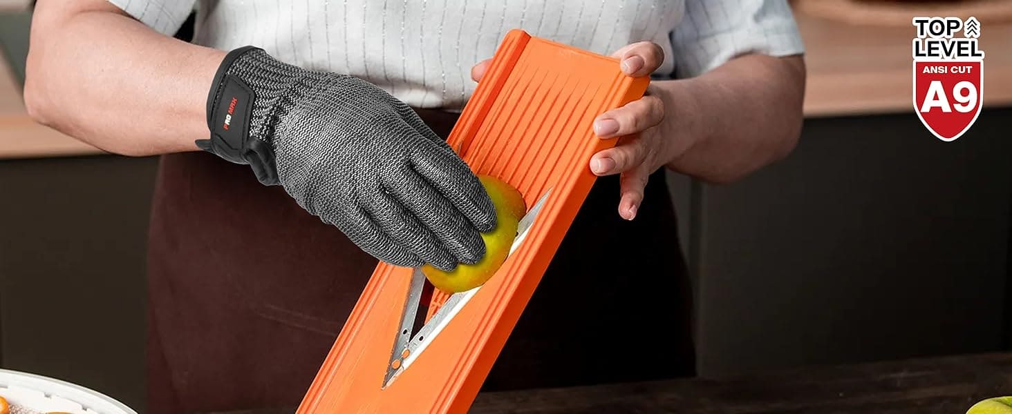 Person using an orange mandoline slicer to cut a lemon, wearing a black glove.