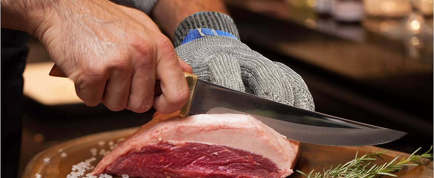 Person cutting raw meat with a knife on a wooden board