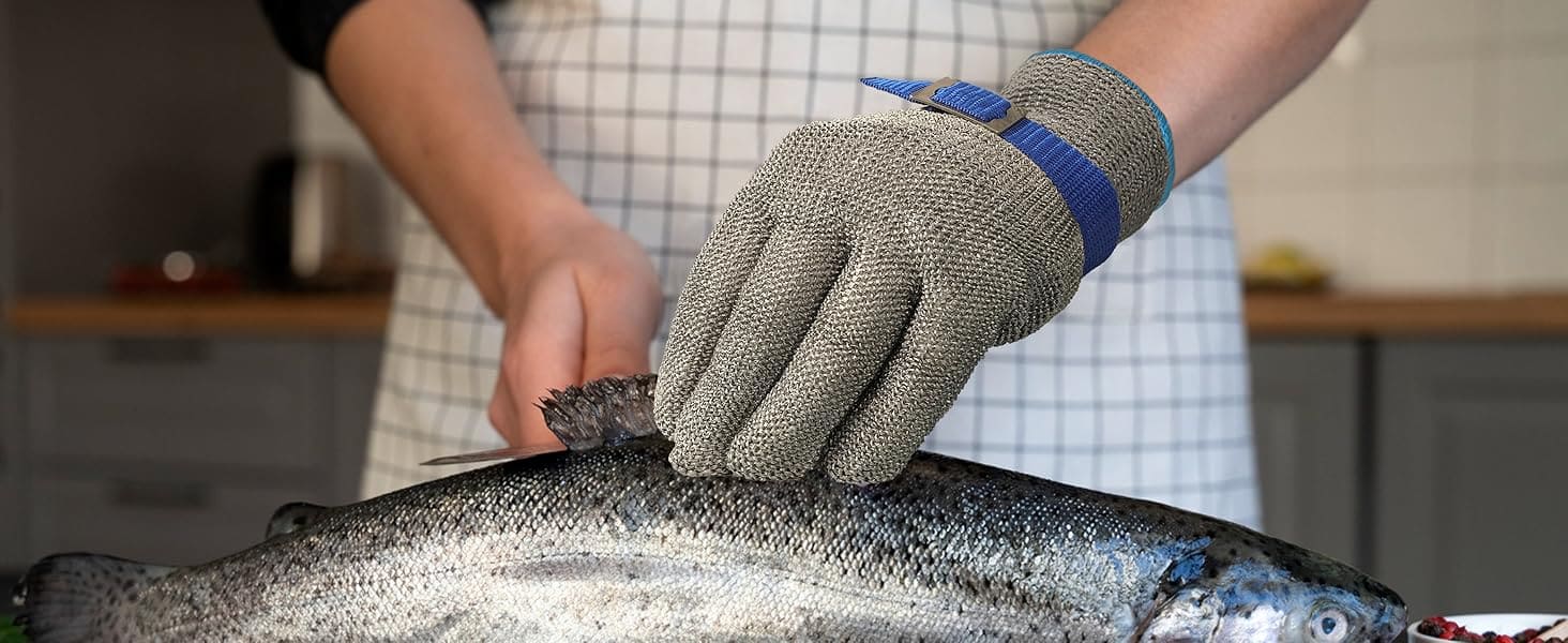 Person wearing a glove handling a fish in a kitchen setting