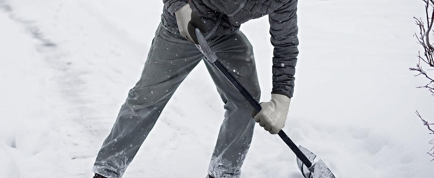 Person shoveling snow in a snowy landscape