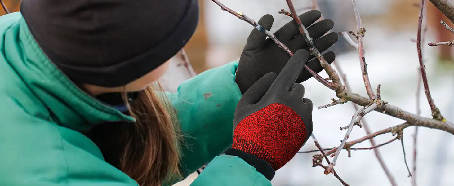Person pruning branches wearing black gardening gloves with red accents.