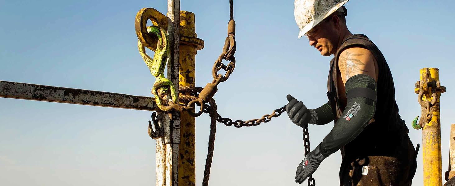 Worker operating a piece of heavy machinery with a clear blue sky background