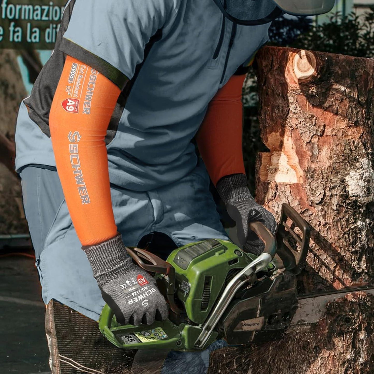 Person using a green chainsaw to cut a log, wearing orange and gray gloves.
