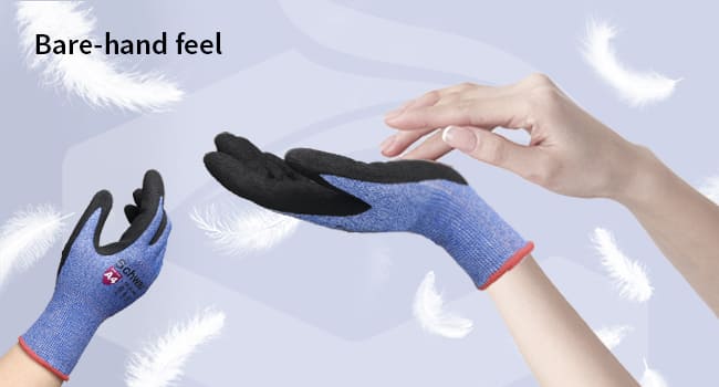 Pair of black and blue gloves held by a person against a light background